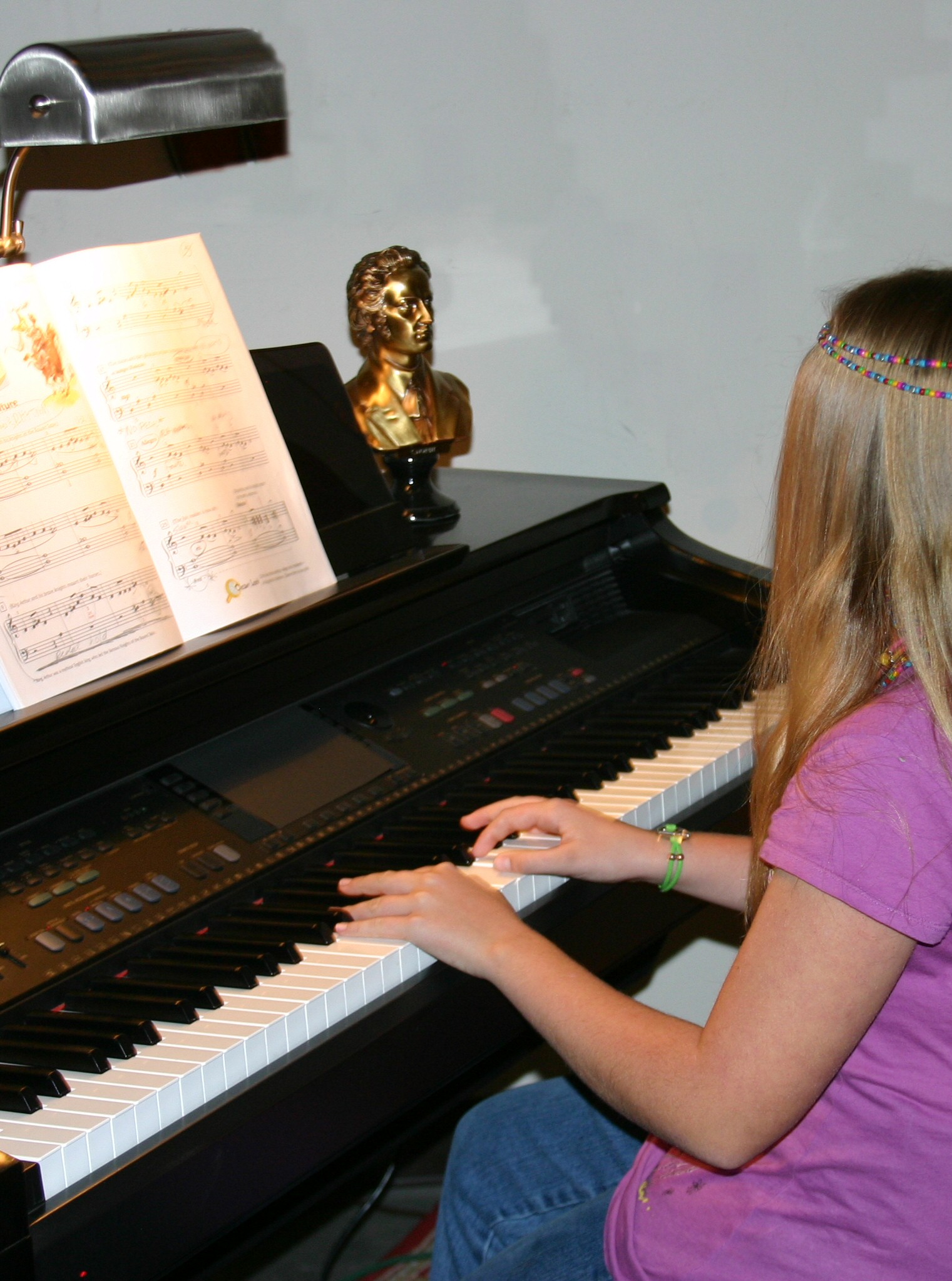 Photo of Leah playing on a digital keyboard