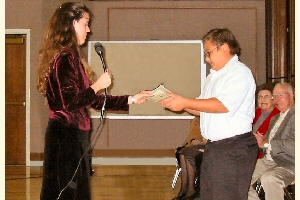 Photo of teacher presenting student with award