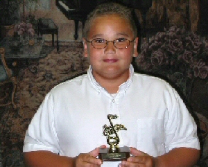 Photo of student holding Golden Note Awards he earned