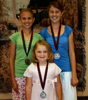 photo of 3 students wearing Medal of Distinction